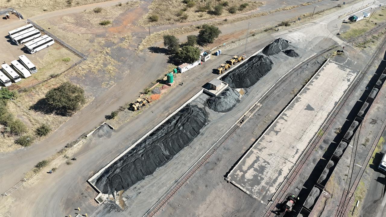 Stockpiles and front-end loaders at the siding